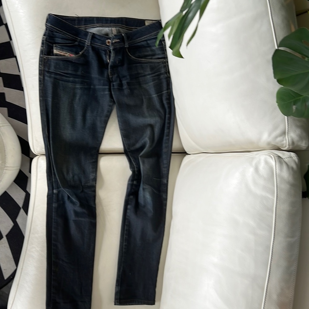 Diesel jeans zip pockets in back.